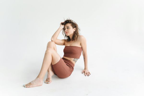 Calm woman meditating in a comfortable seated yoga pose.
